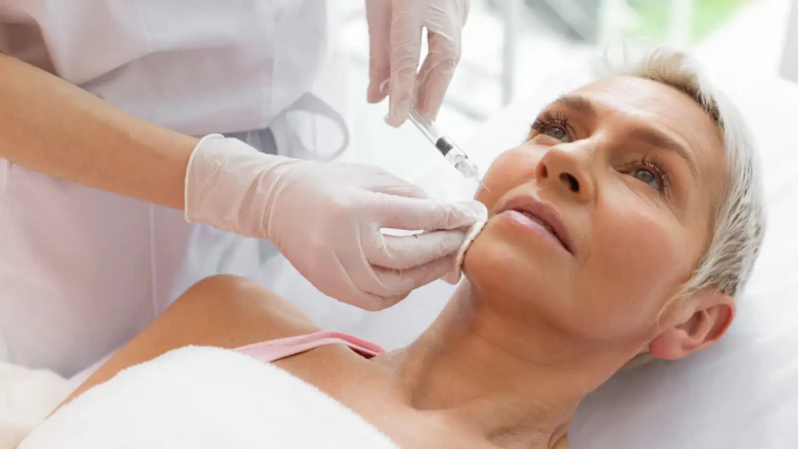 Woman getting facial injection.