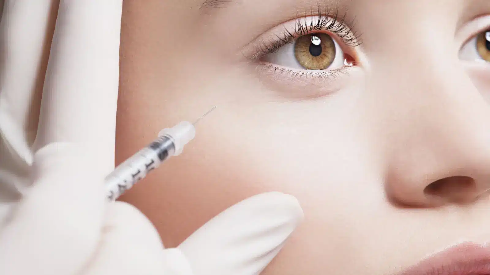 Woman getting facial injections. 