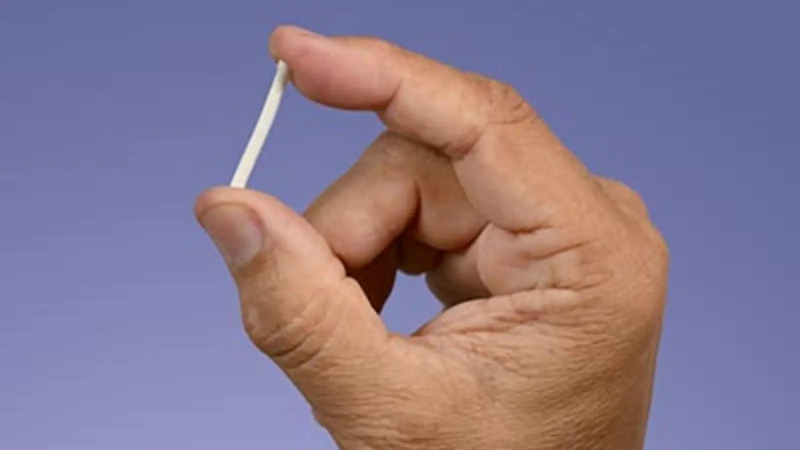 Person holding an implant. 