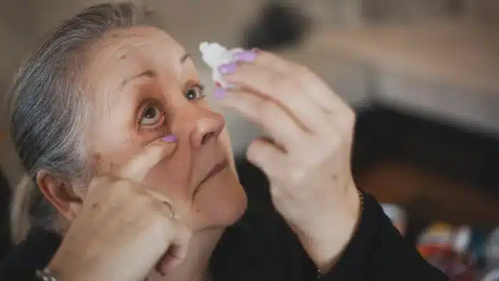 Person putting eye drops.
