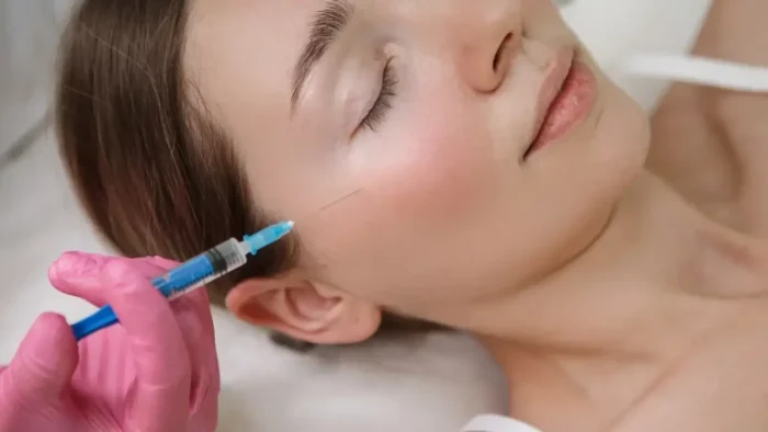 Person getting facial injection.