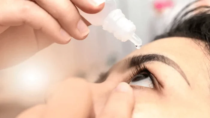 Person putting eyedrops.