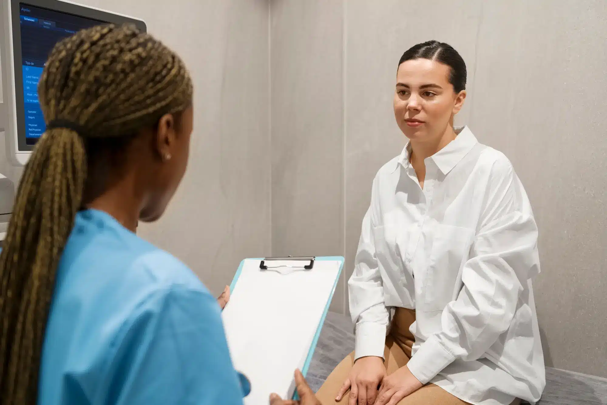 Female patient speaking with female healthcare practitioner.