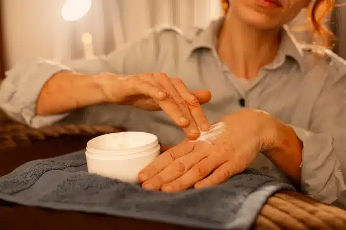 Person with cream on their hand.