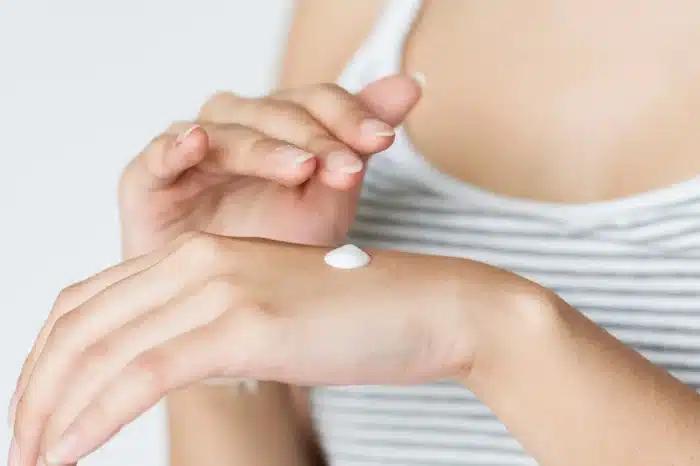 Person with cream on skin.