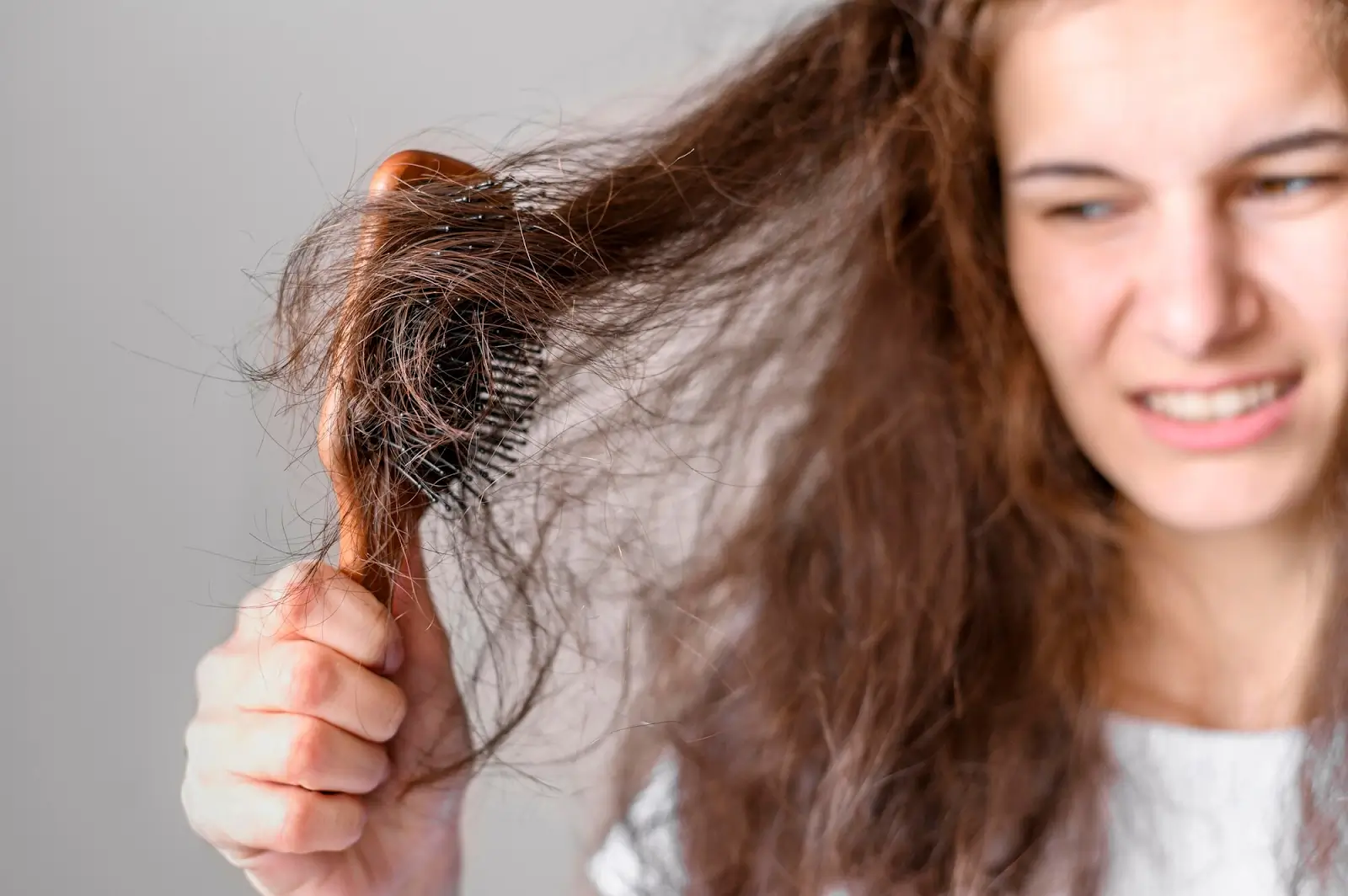 Person combing hair.