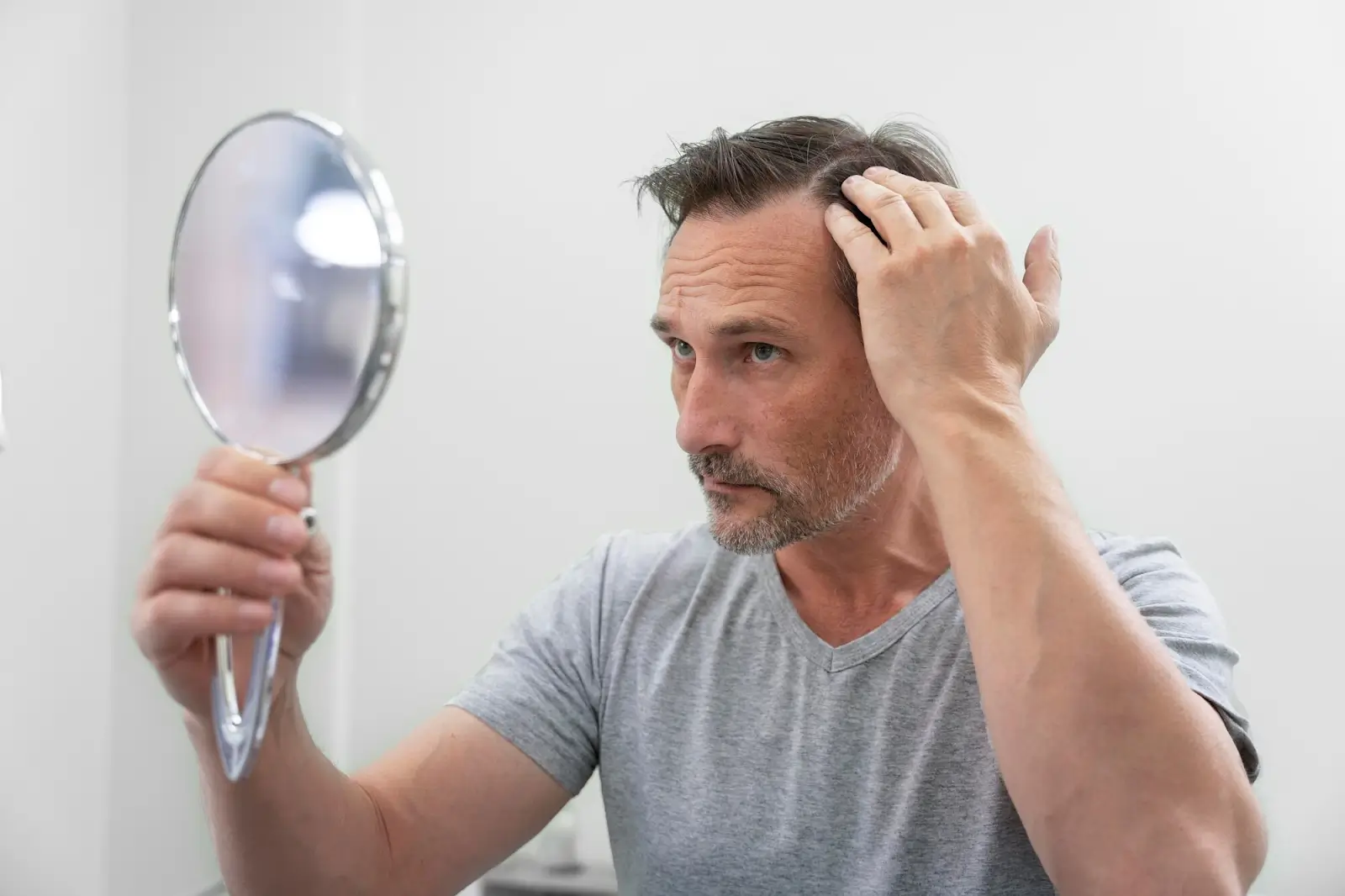 Man looking in the mirror.