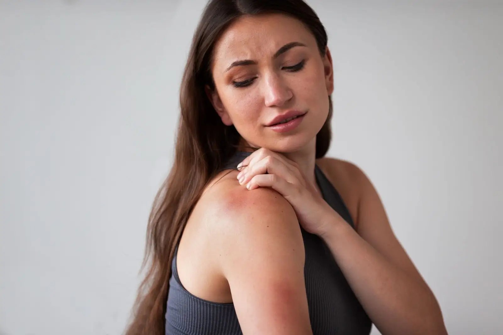 Person itching her shoulder.