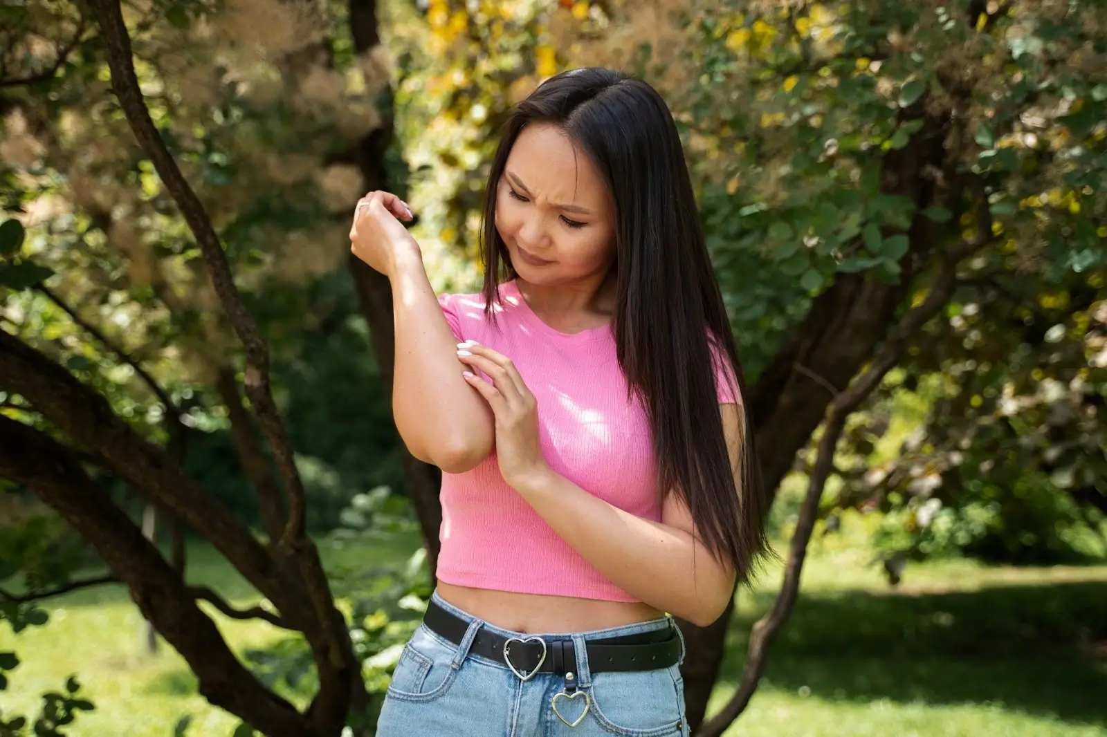 person itching arm.