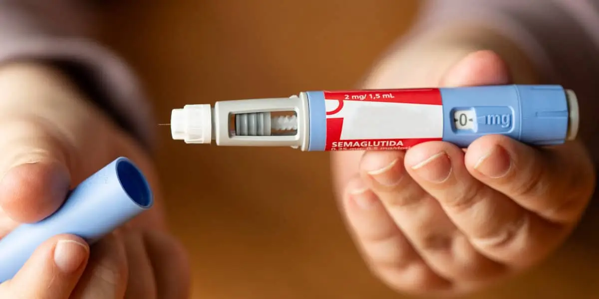 Person holding ozempic injection.
