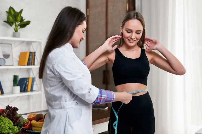 Doctor checking waist. 