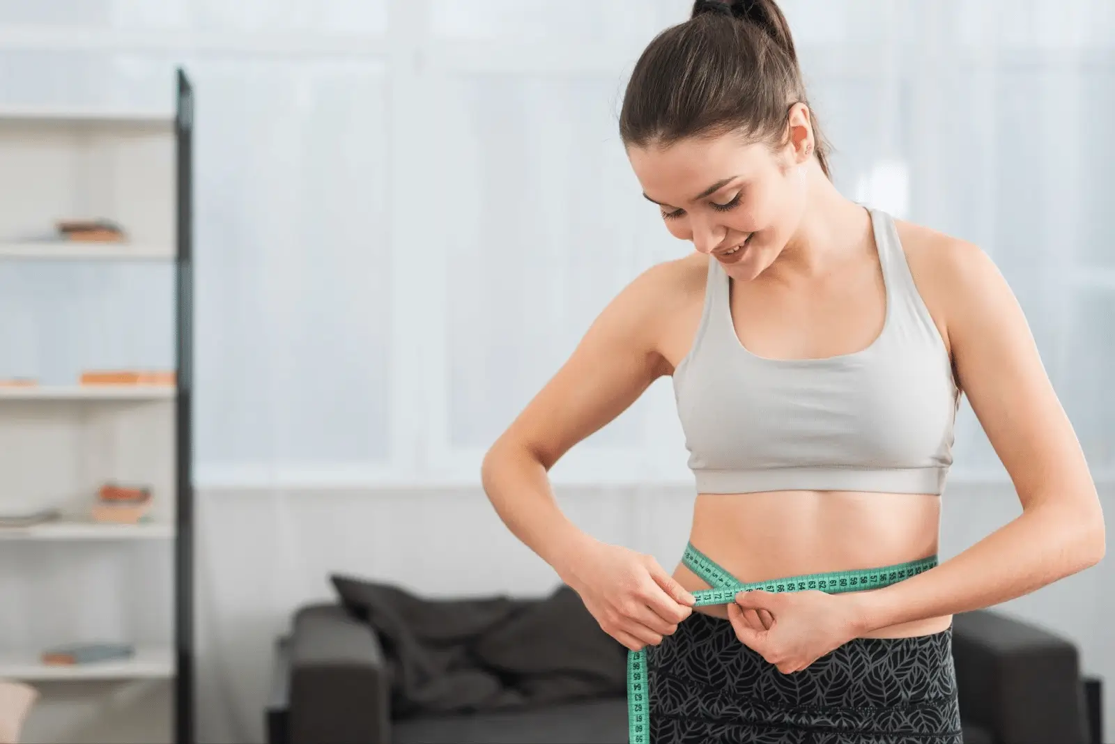Person measuring her waist.