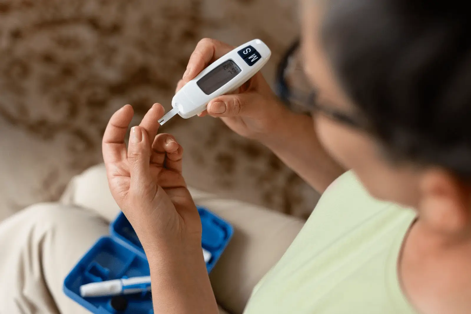 A woman is checking her blood sugar before using Mounjaro treatment.