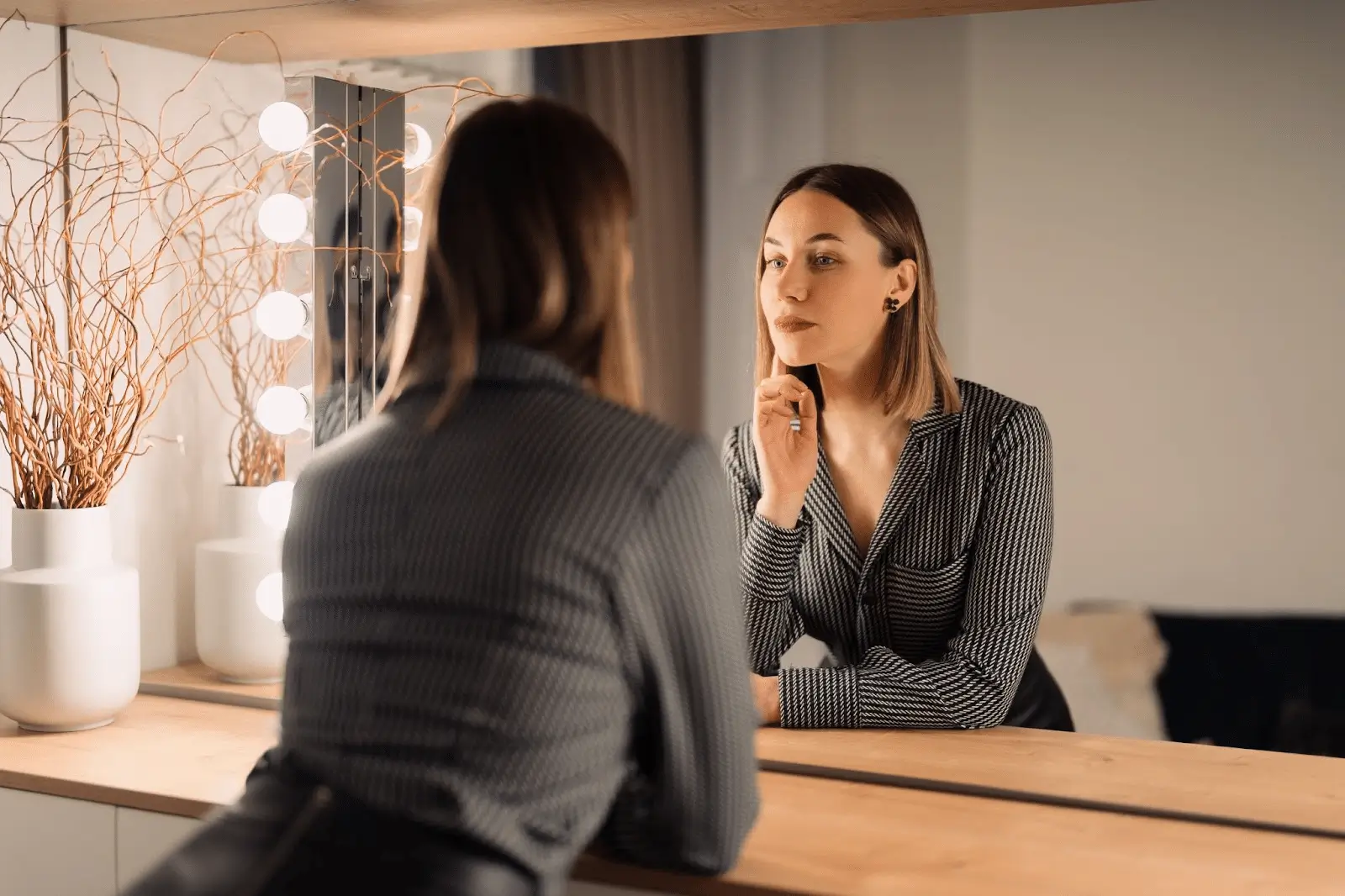 Person looking into the mirror after PRX-T33 treatment.