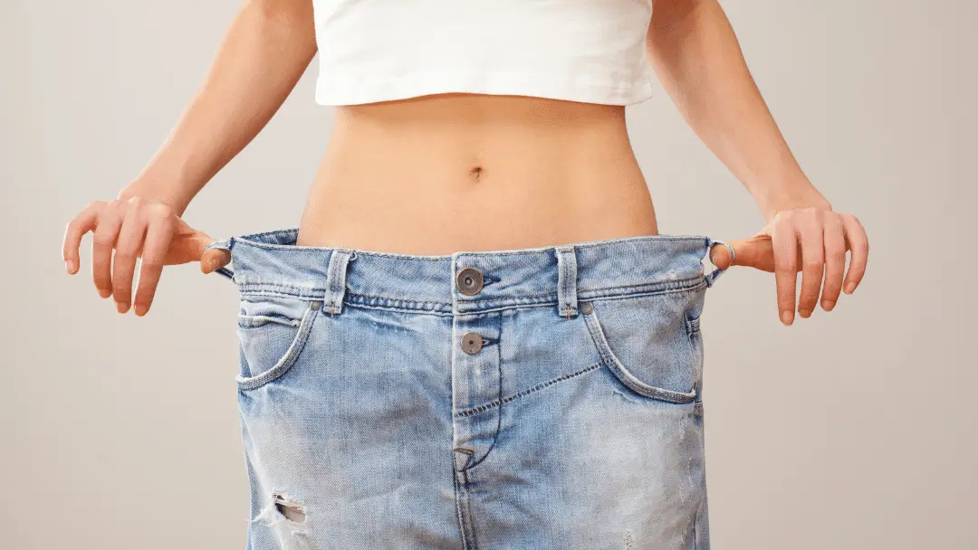 A person holding pants because they are loose. 