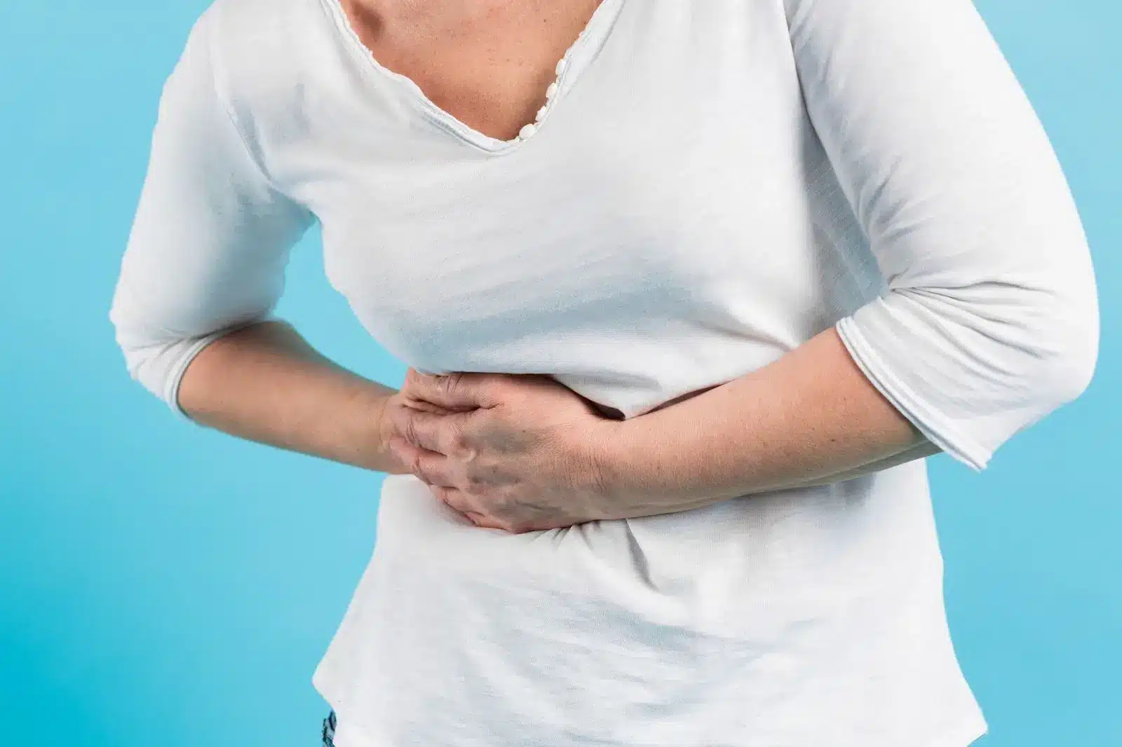 A person clenching stomach because of pain.