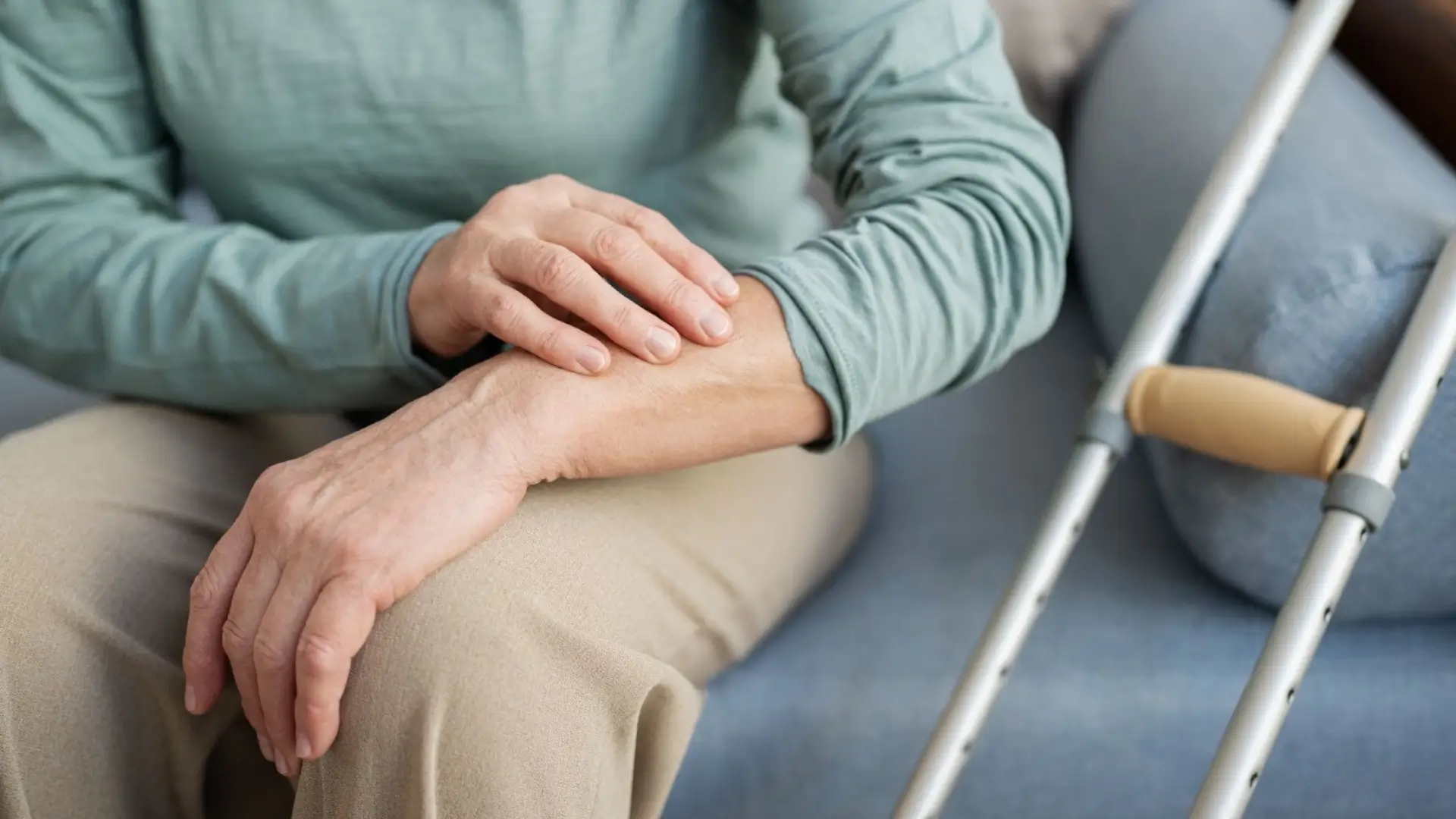 An old lady with a crutch on her side. She is taking Evenity treatment.